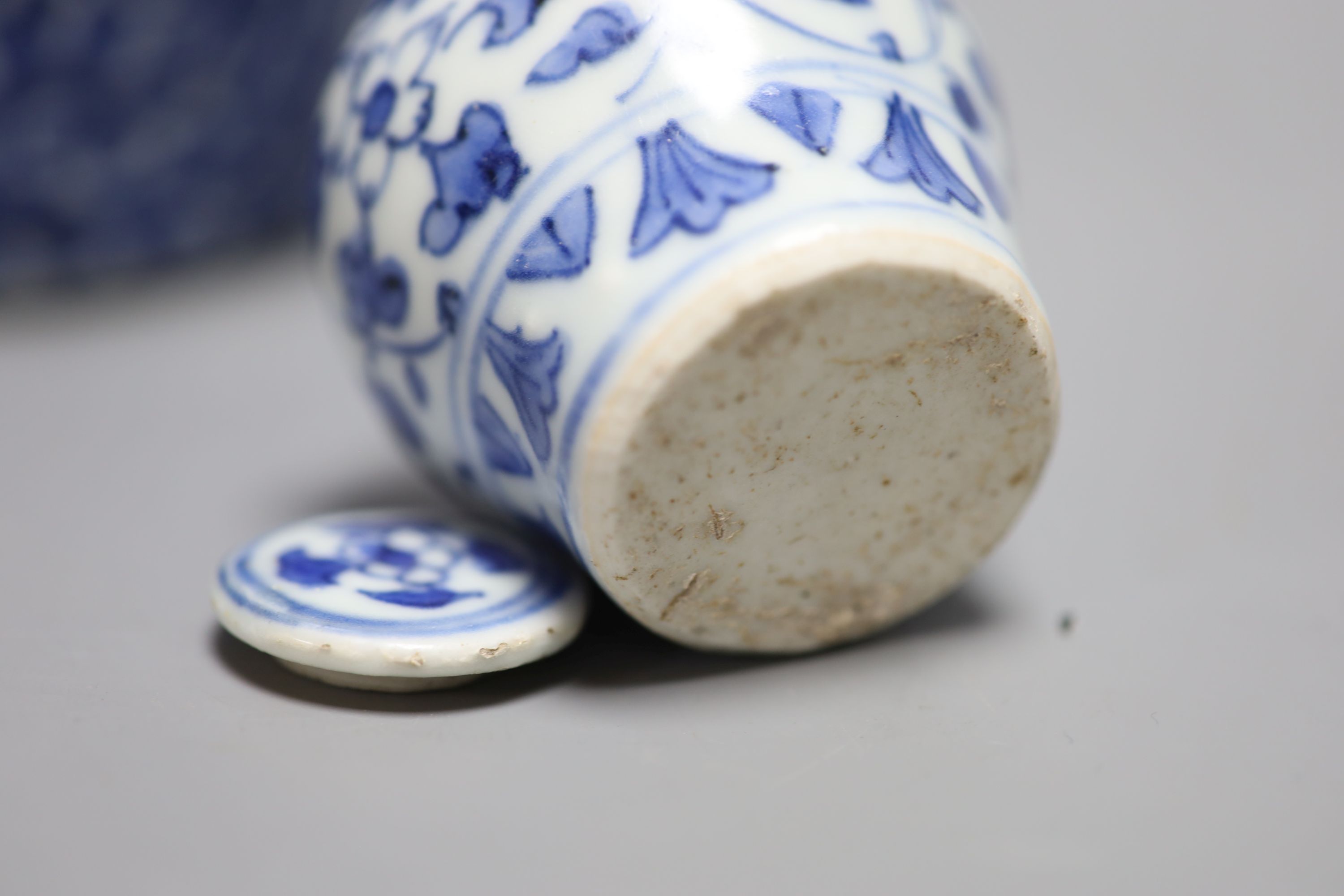 A Chinese blue and white lotus jar and cover, early 20th century, a similar dragon vase and a small Kangxi jarlet and cover, talles